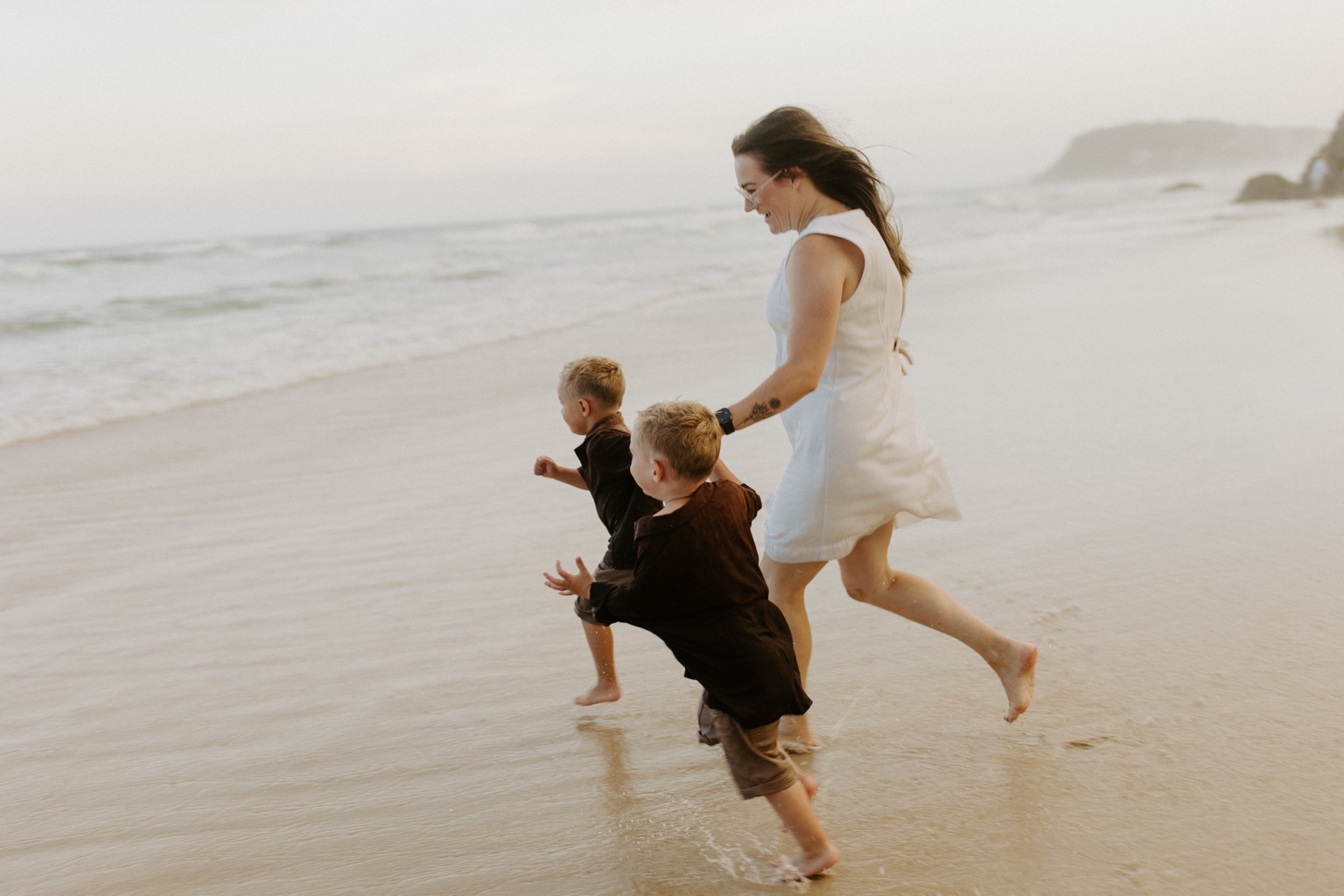 Shenae running along the beach with her children